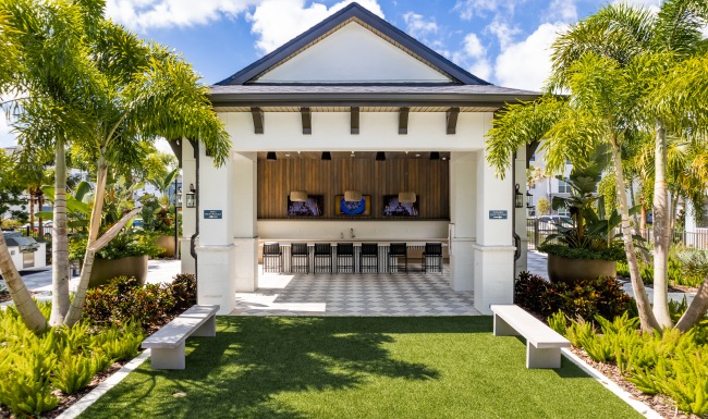 outdoor lounge with grill and green space