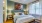 a bed with a blue and white comforter at The Shores at Lake Howell Apartments in Casselberry, FL